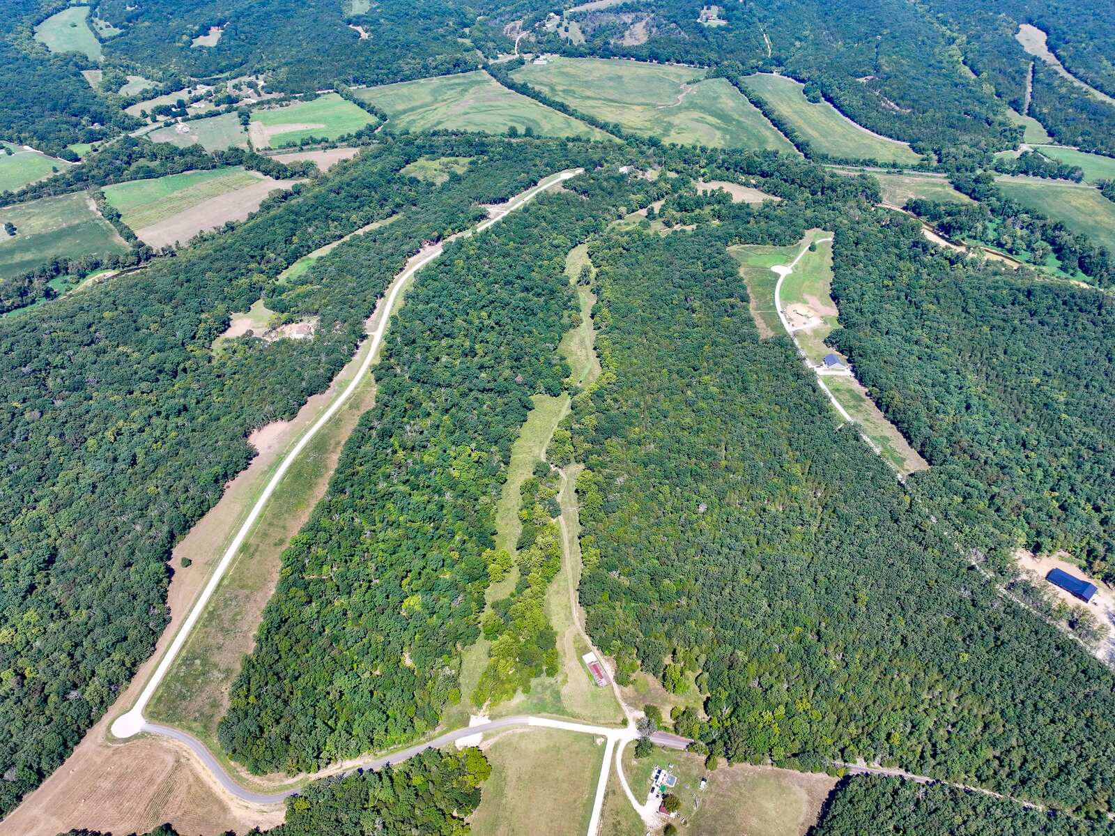 Wide aerial view of Tanglefoot Farm's surveyed parcels, roads, and timber outside Festus, Missouri