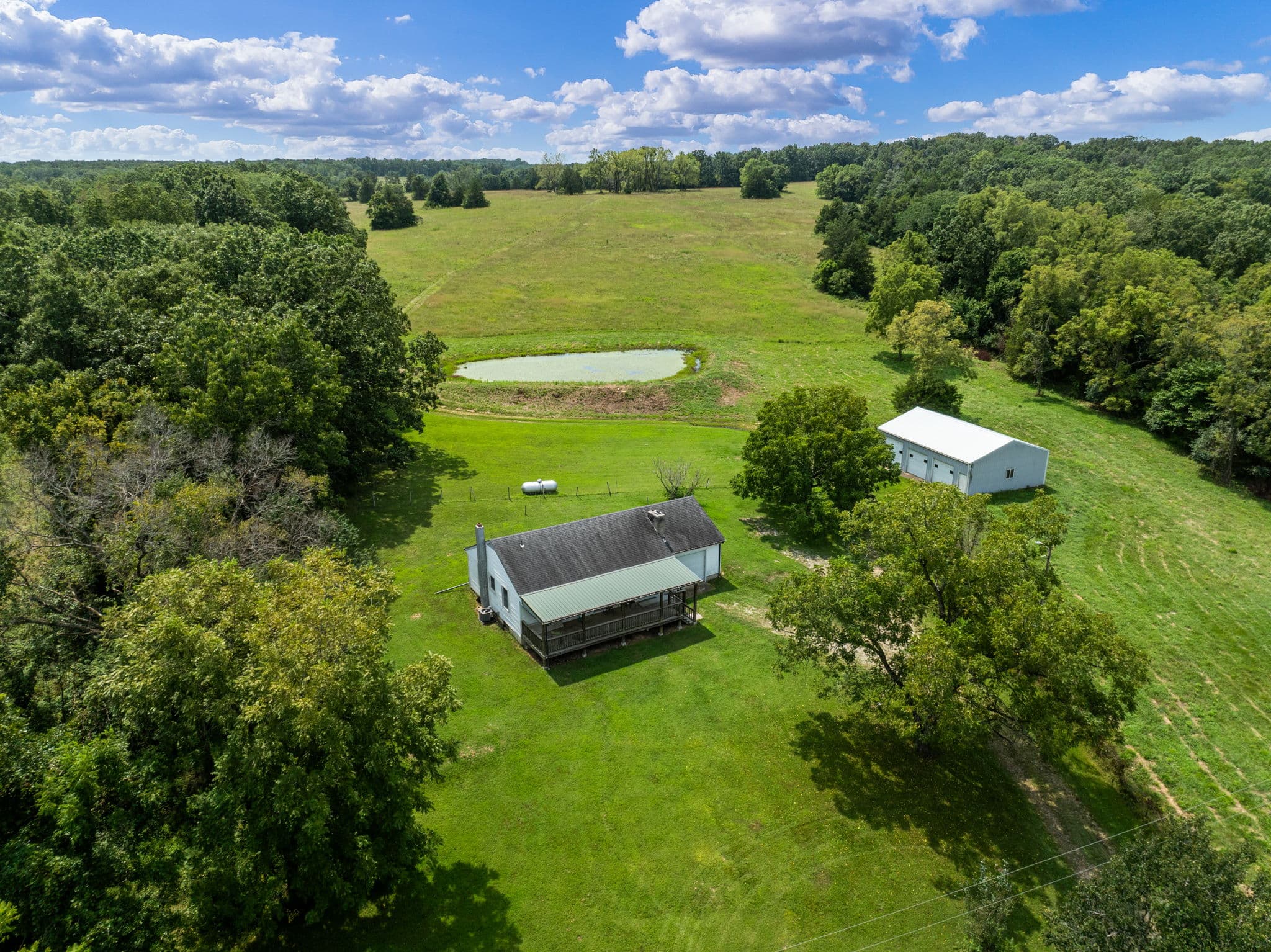 Aerial of the homestead, barn, and pond on the ridge