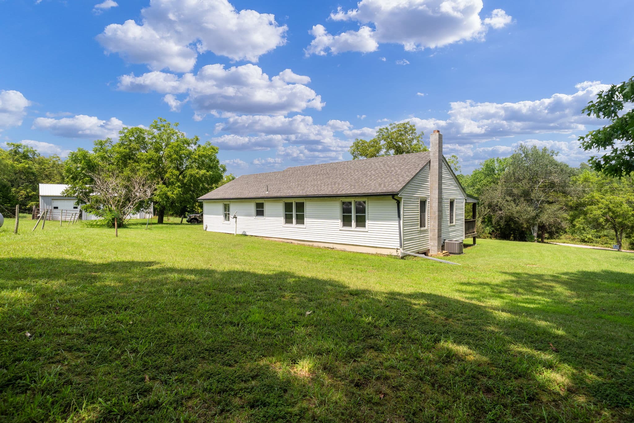 White farmhouse and shaded yard