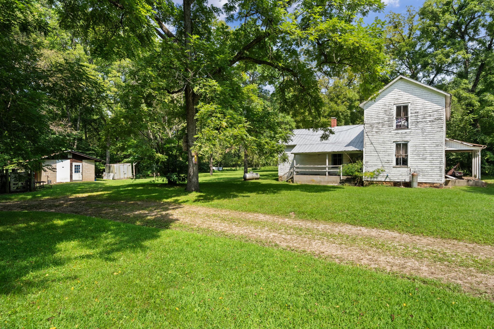 Farmhouse and outbuildings along the drive
