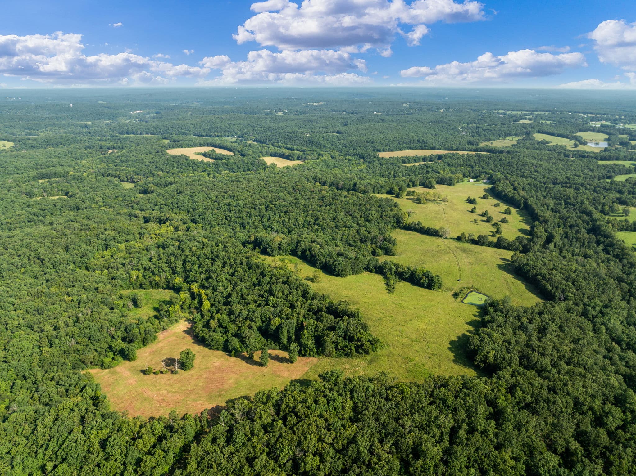 Aerial across the ranch toward the Ozark horizon