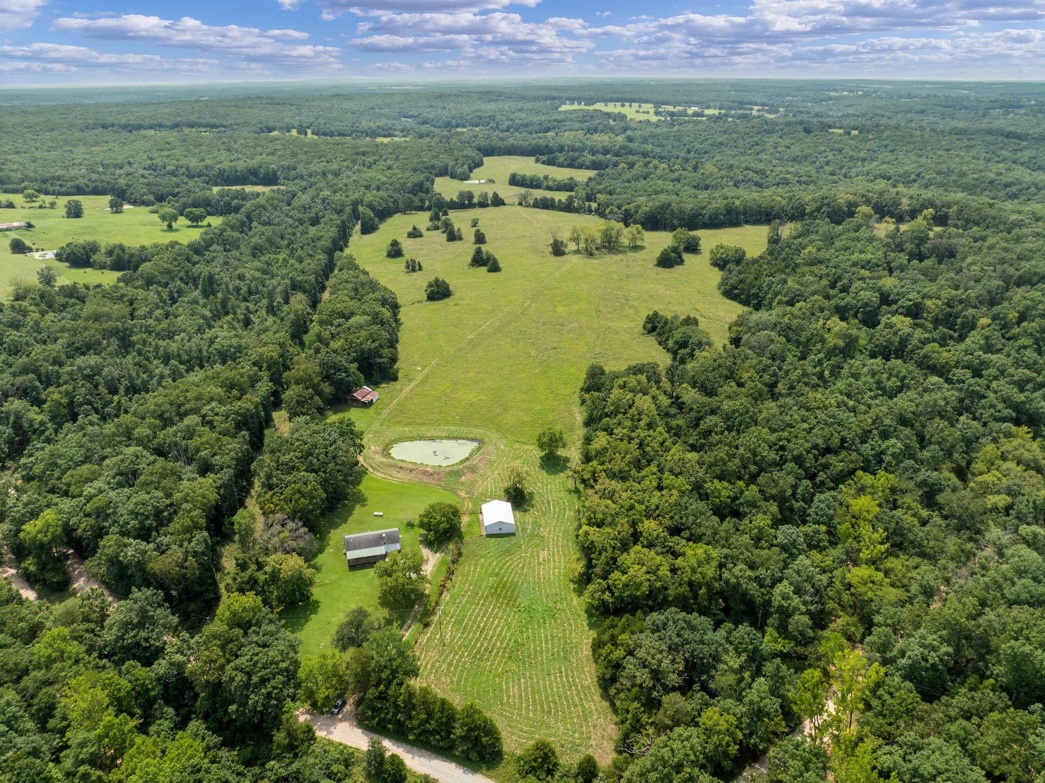Aerial of the pasture, pond, and outbuildings
