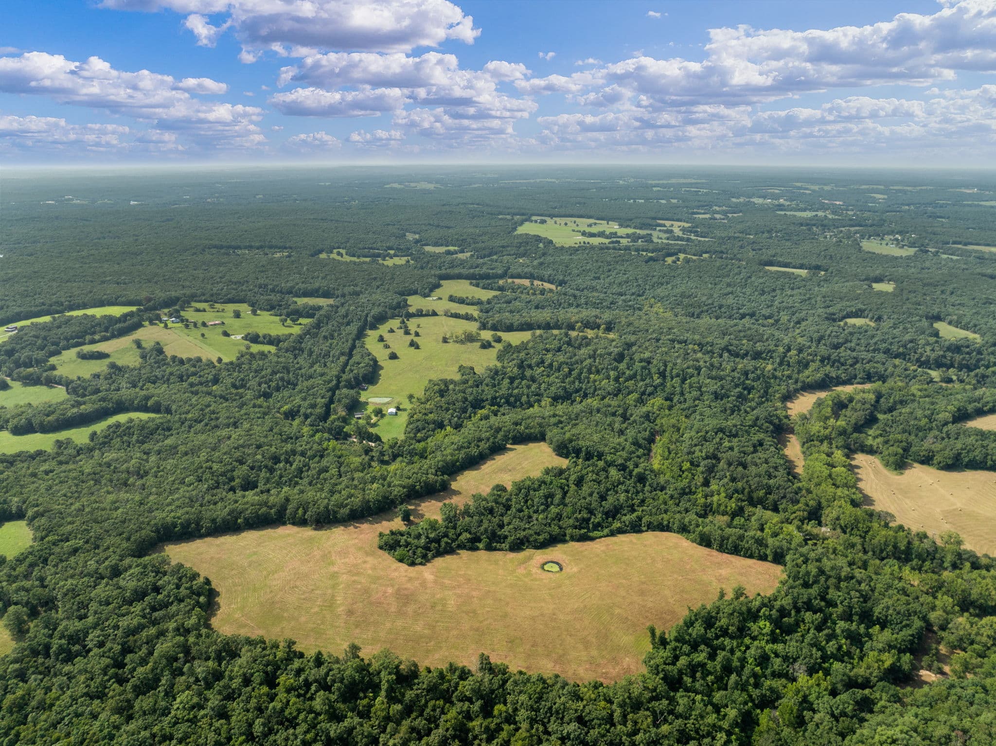 Aerial of pasture, timber, and ridgeline views