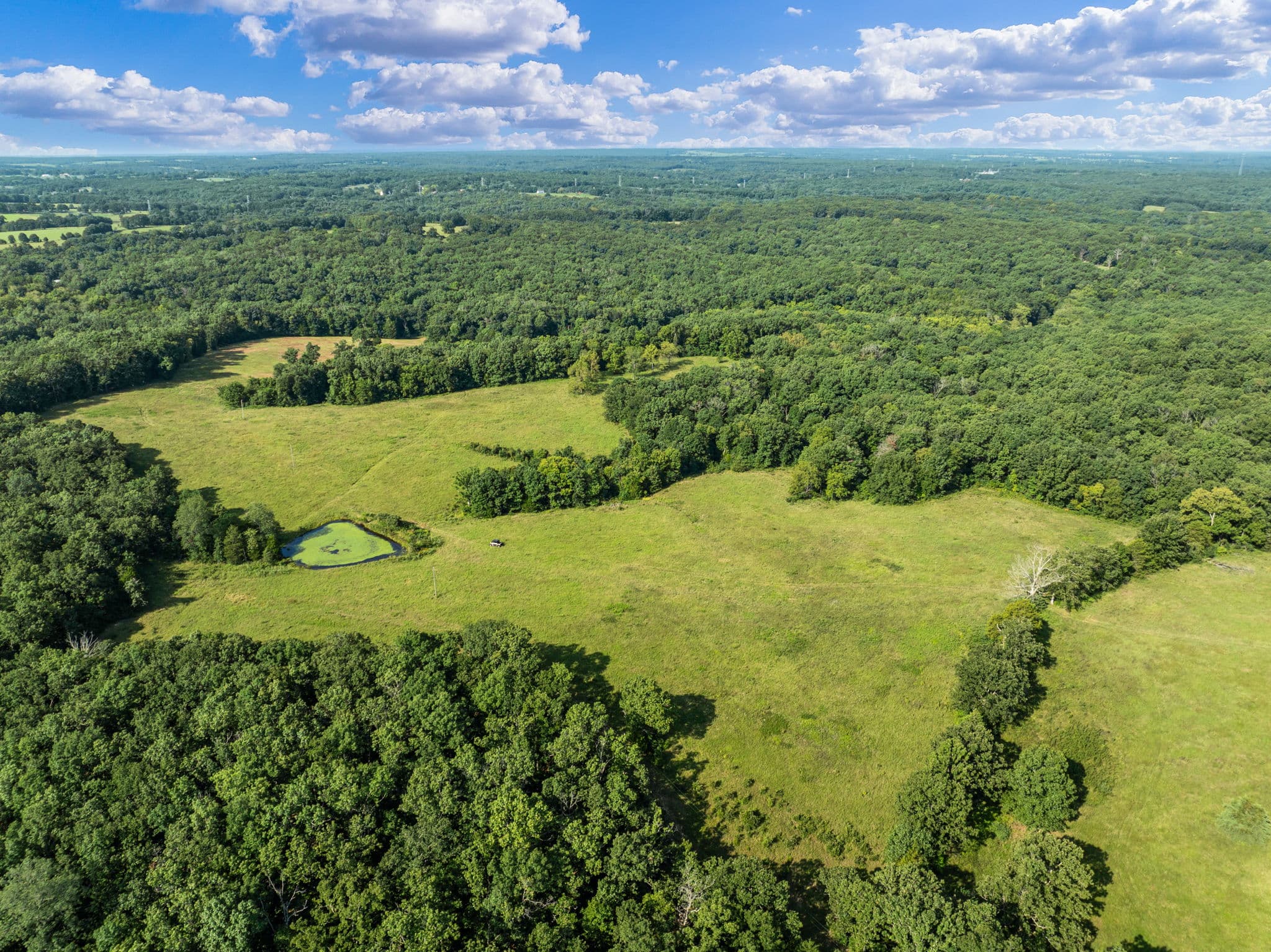 Aerial of pasture with a stock pond