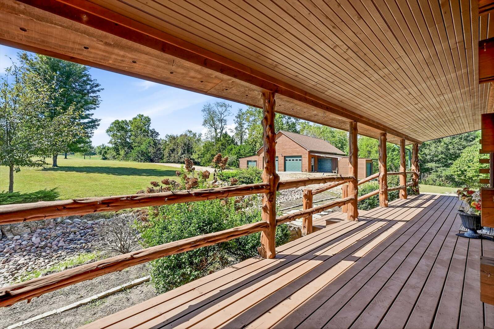 Covered porch looking out over the yard and outbuilding
