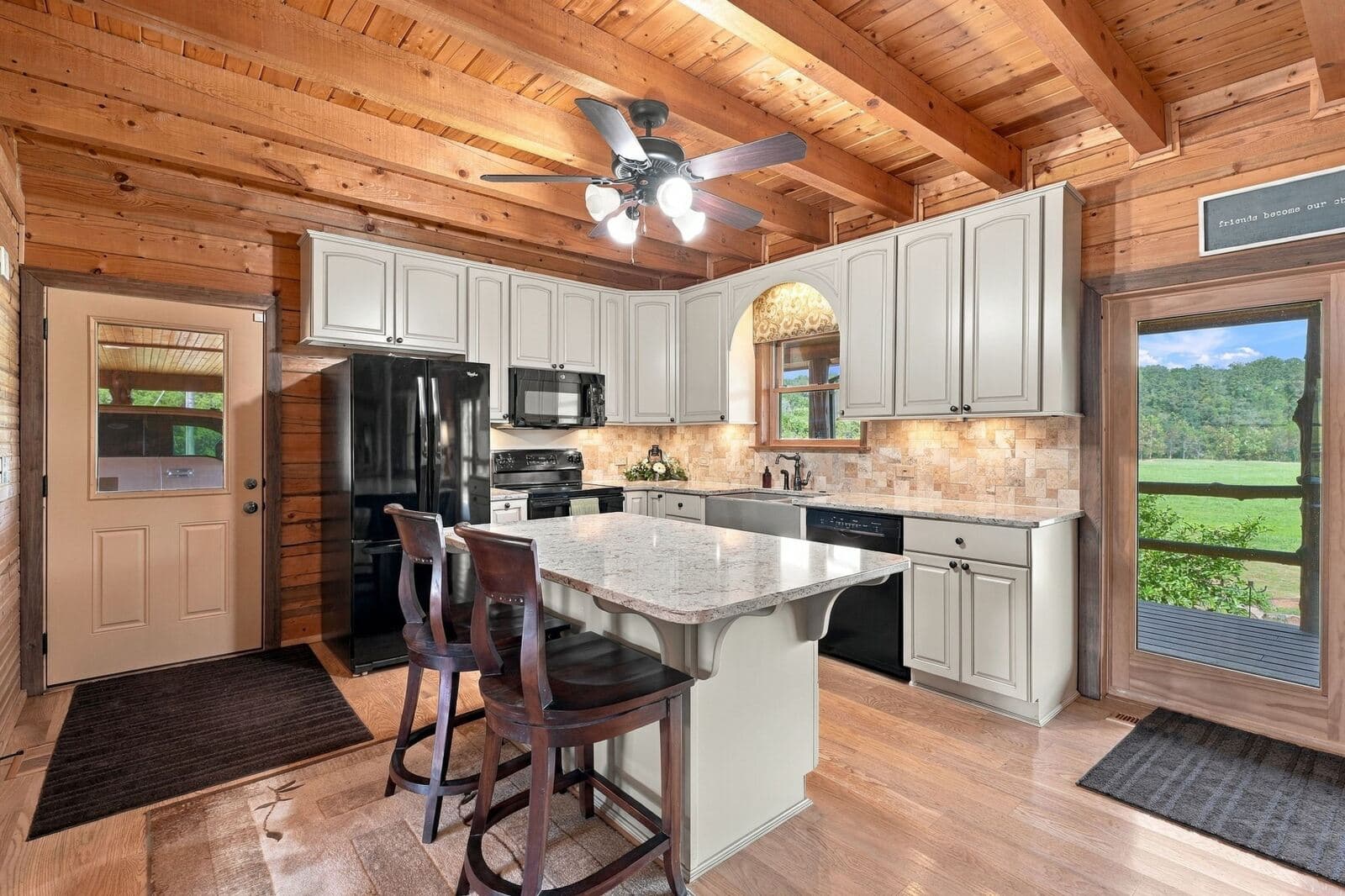 Kitchen with island seating and view out the back door
