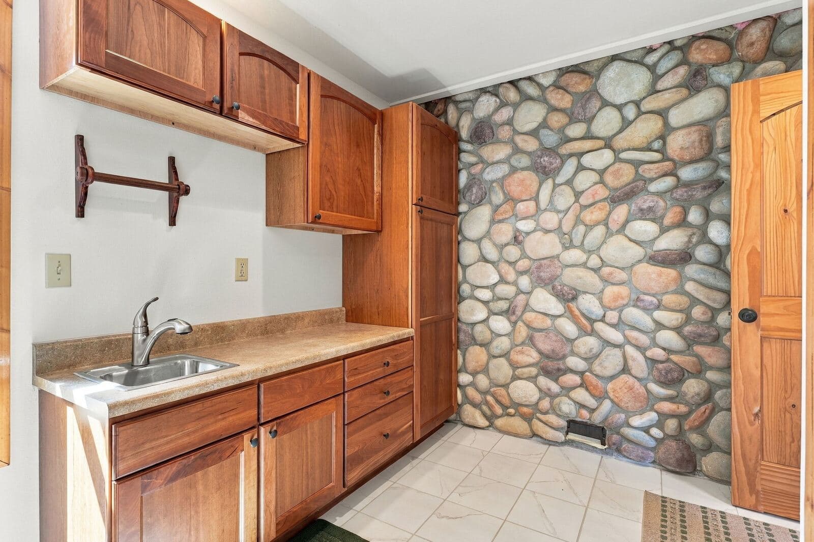 Wet bar with river-rock accent wall