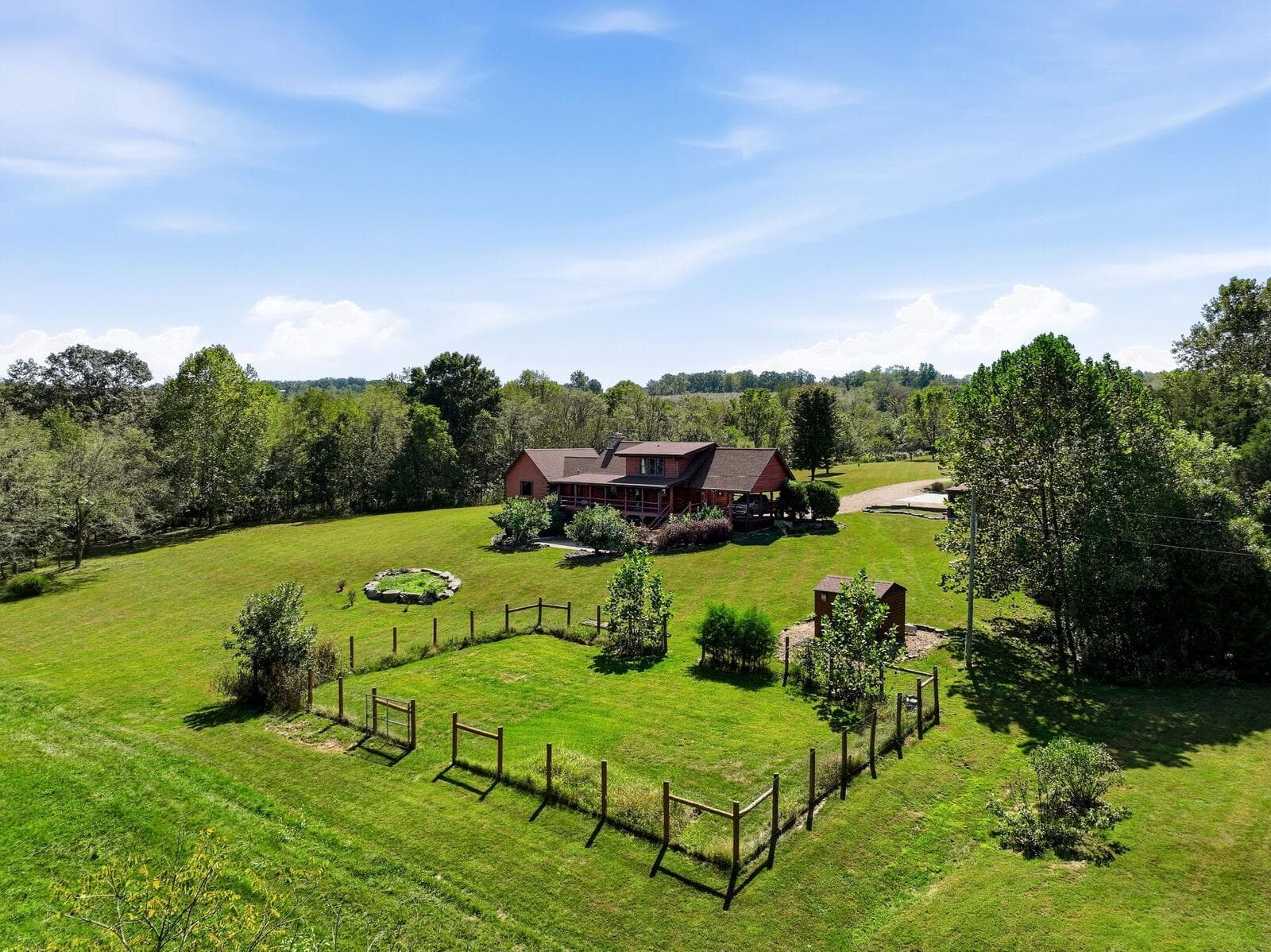 Aerial of the log home and fenced garden at Meramec Trails