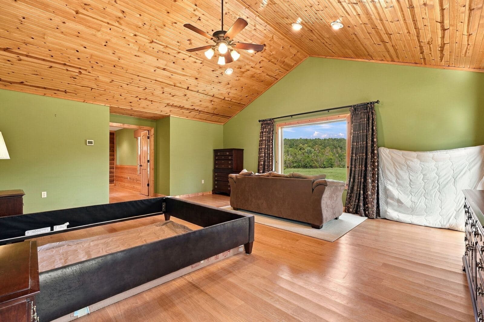 Master bedroom with sitting area and window views