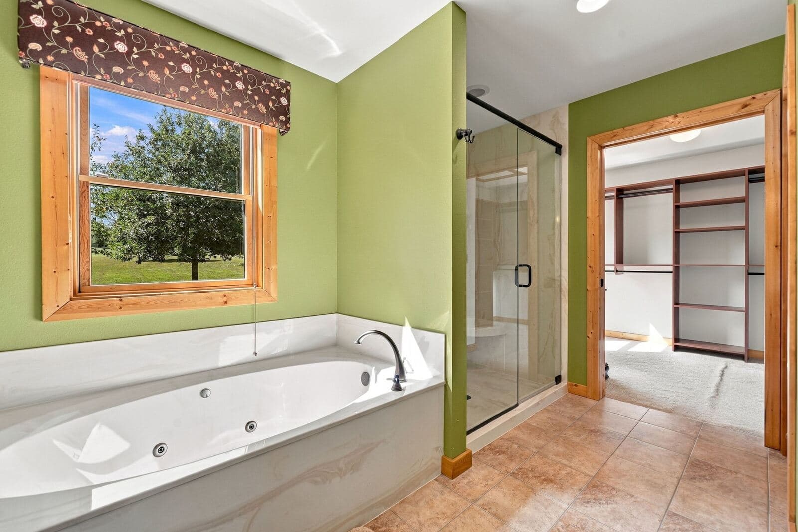 Master bath jetted tub beneath a picture window