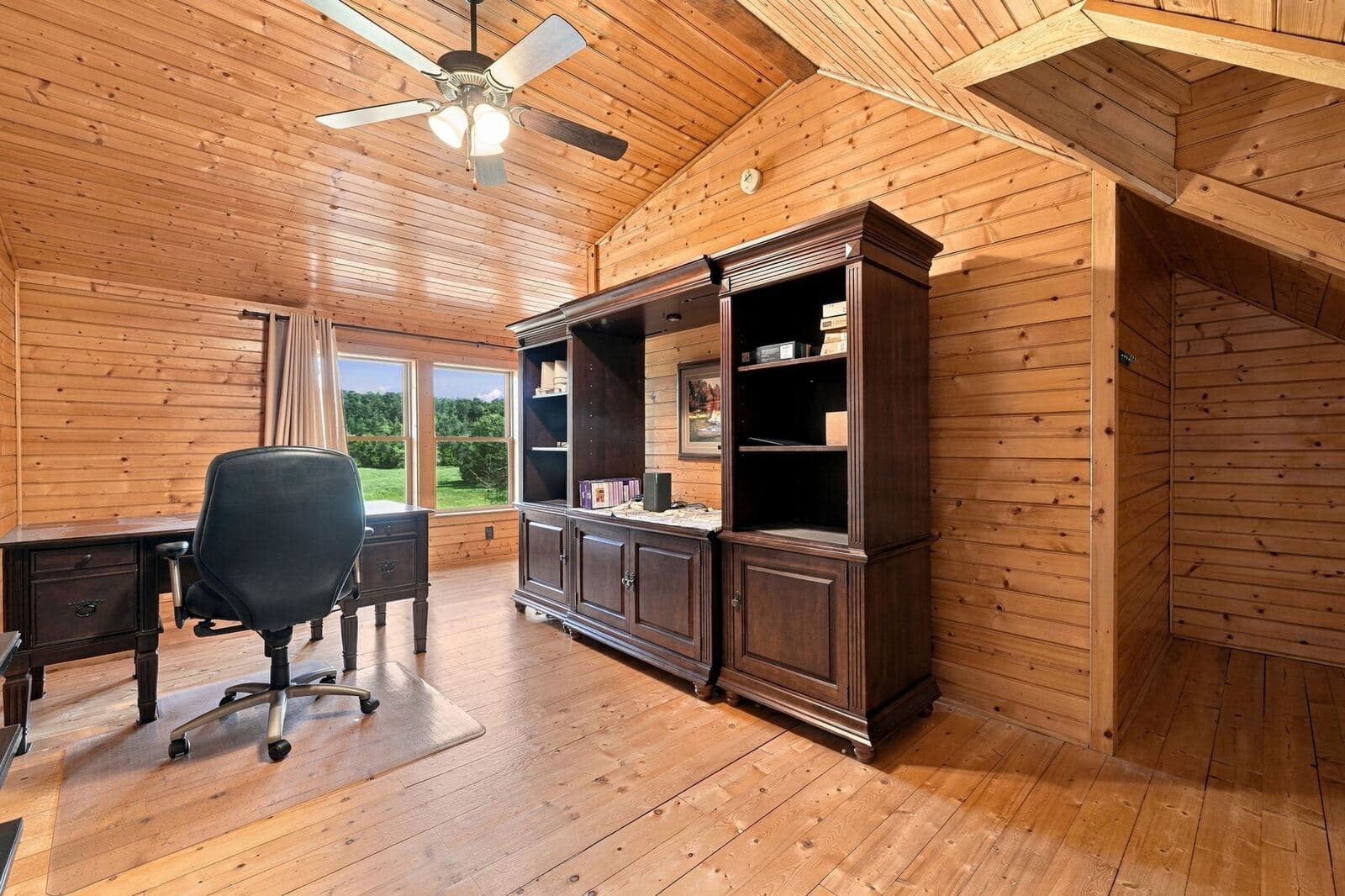 Home office with built-in desk and windows