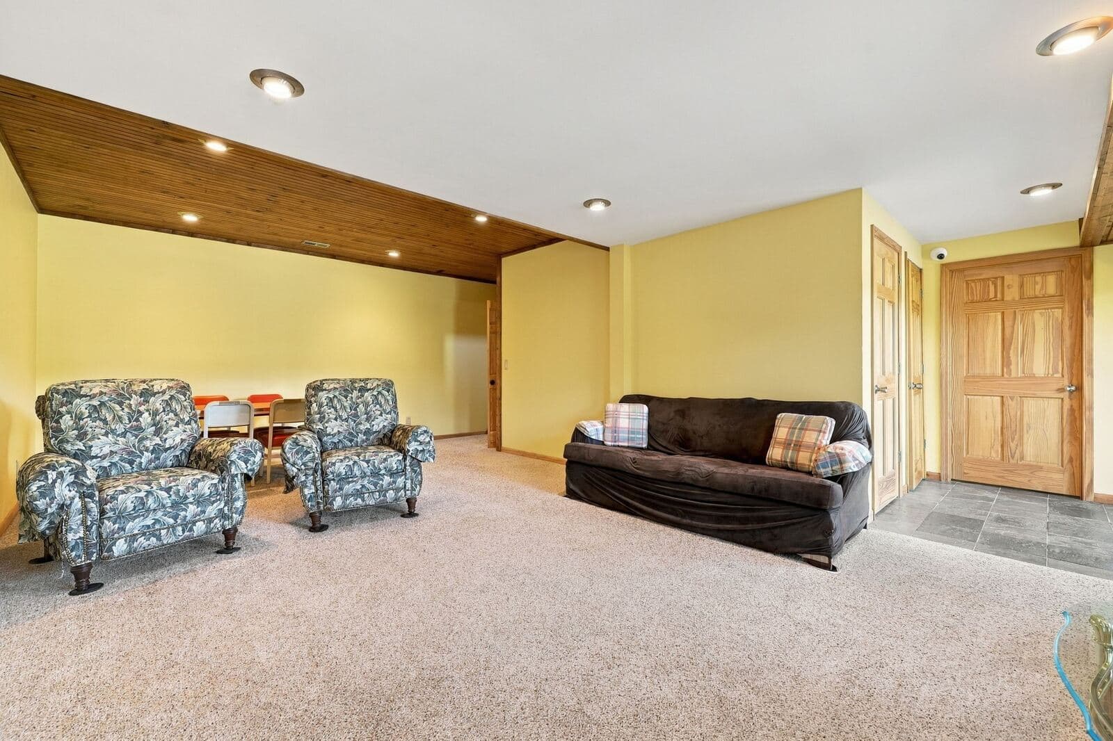 Lower-level family room with carpet and seating