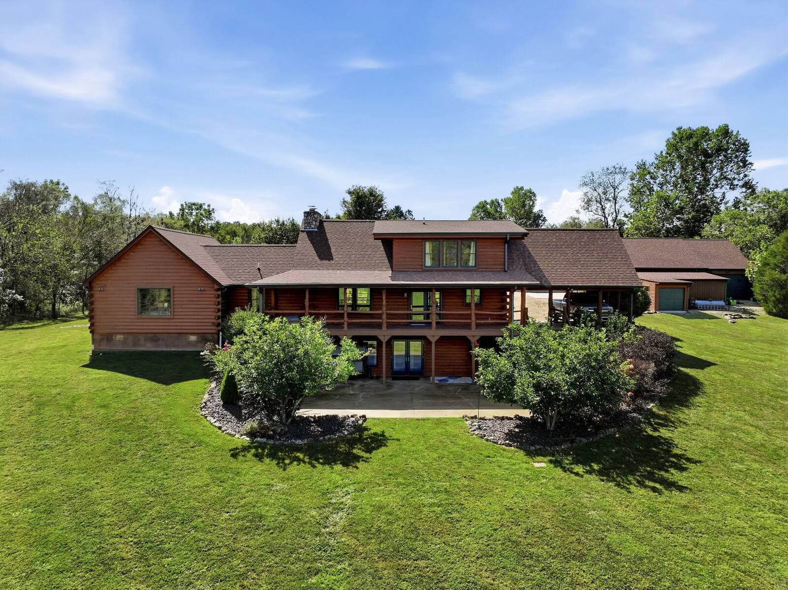 Aerial of the log home and wraparound porches