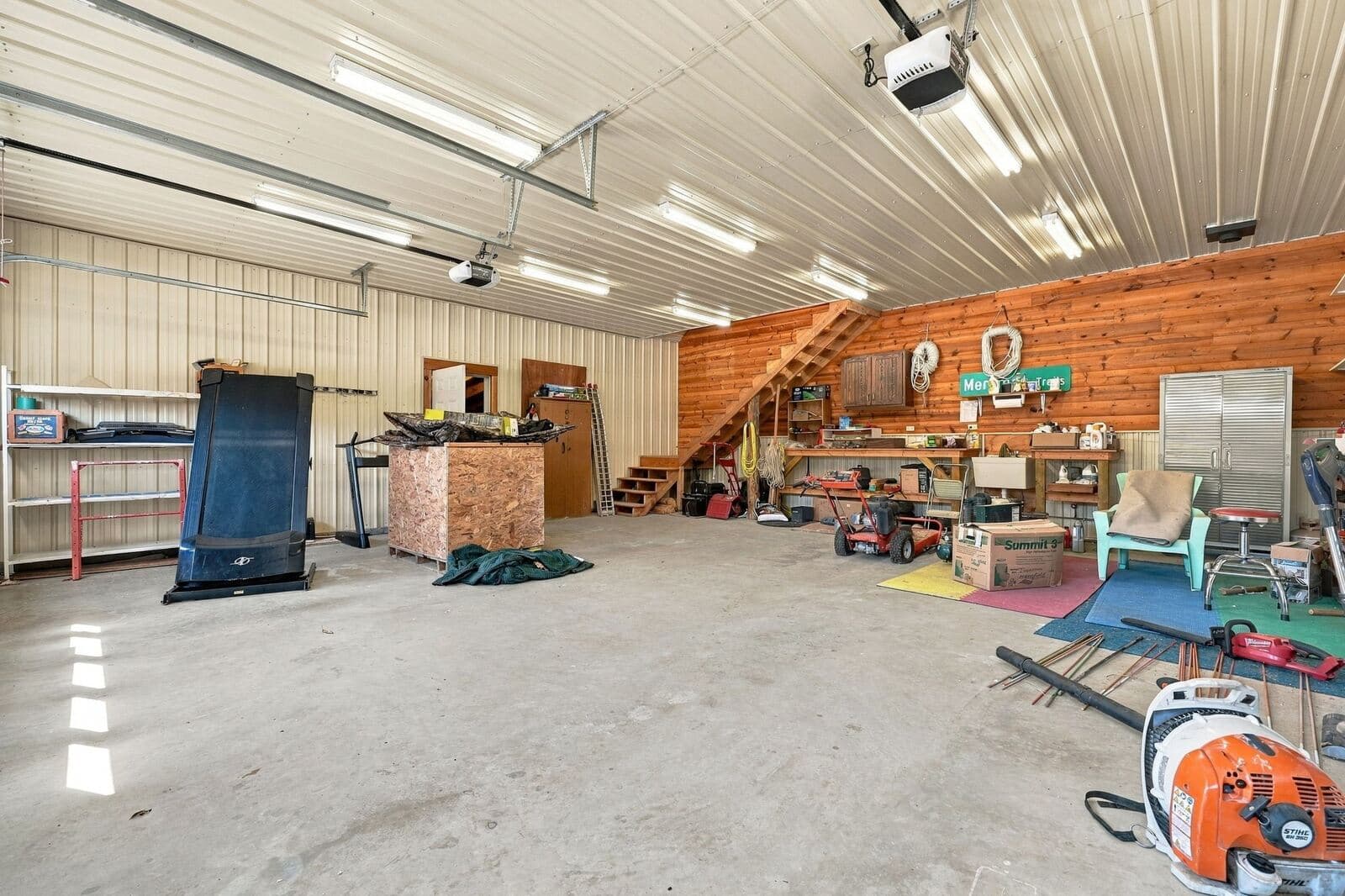 Inside the garage with workbench and storage