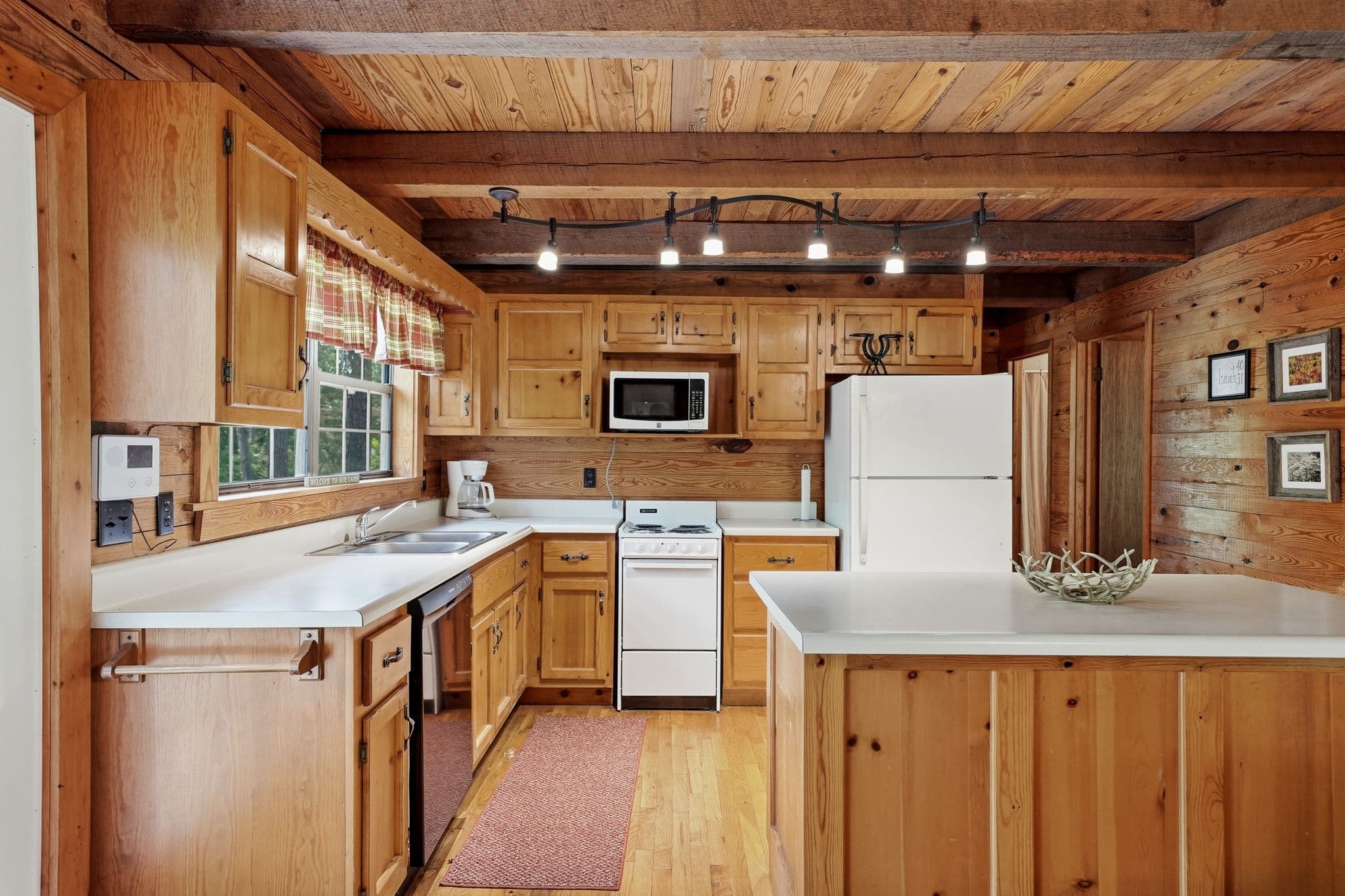 Kitchen counters, range, and pine cabinetry