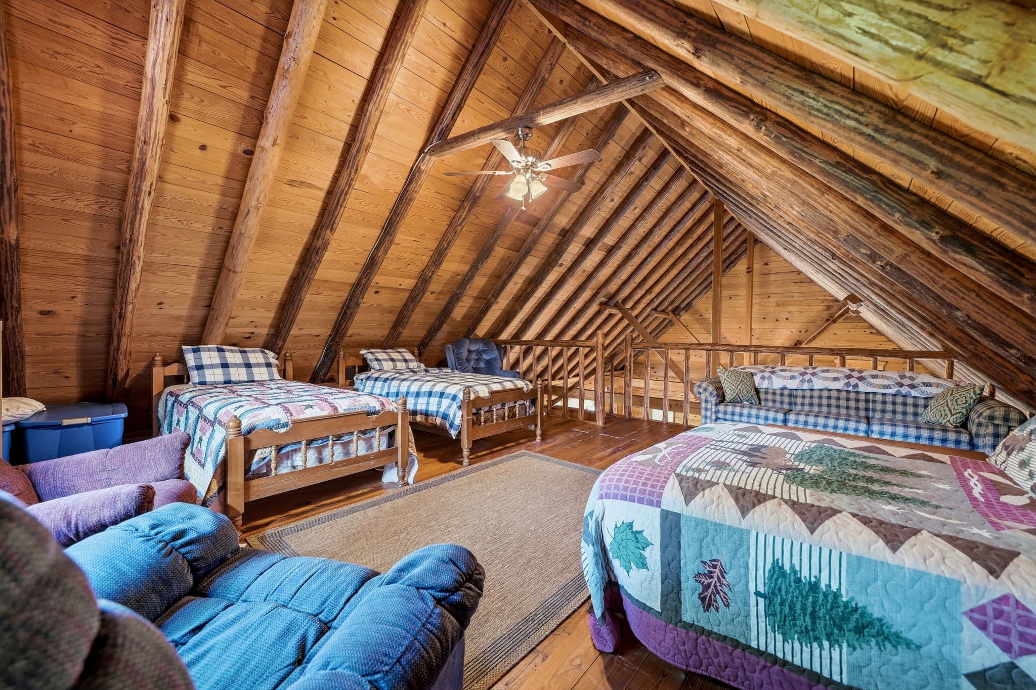 Loft beds and lounge seating under exposed rafters