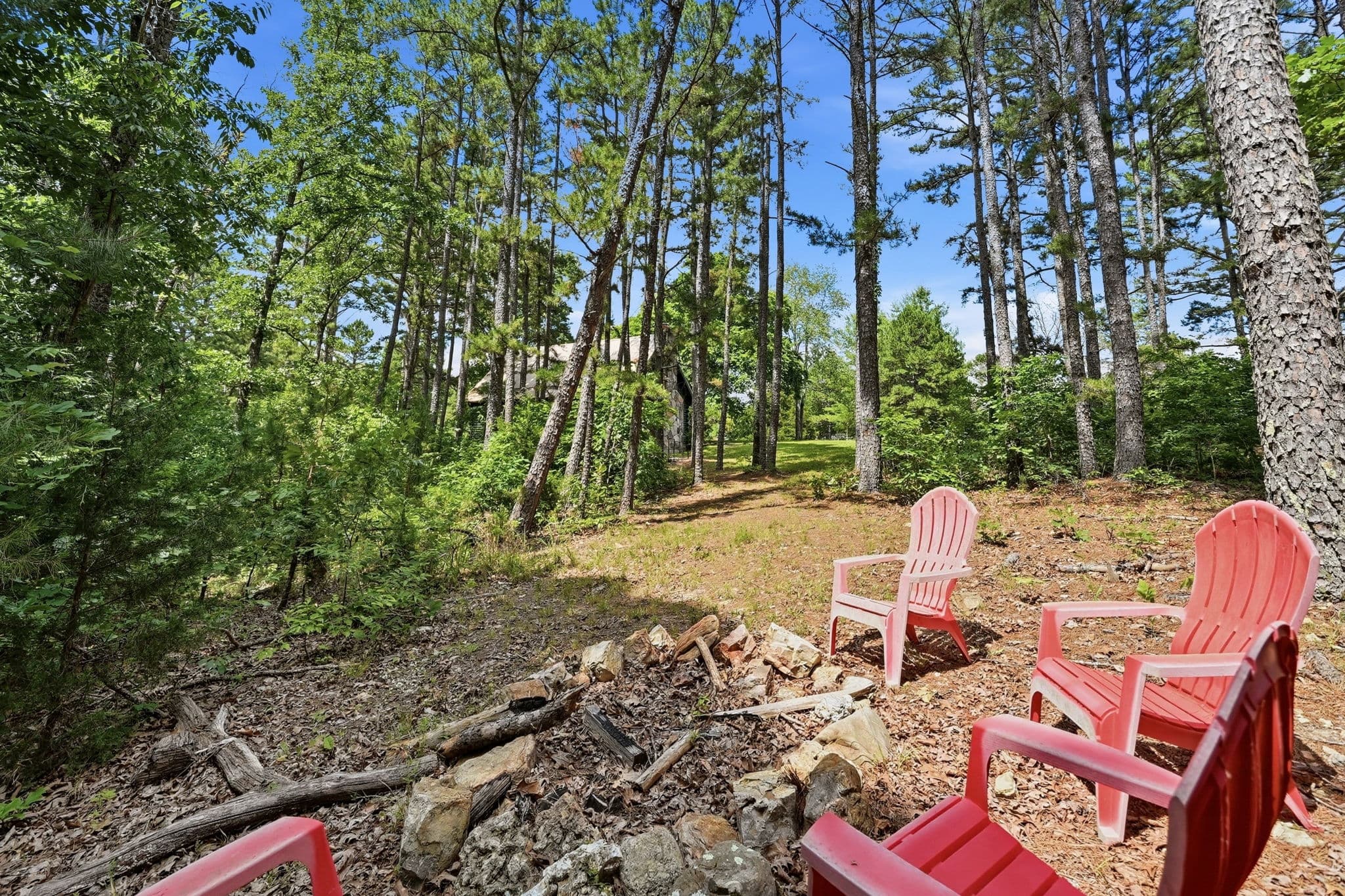 Adirondack chairs around the stone fire ring